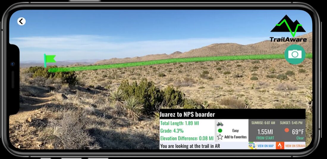 TrailAware app drawing a glowing AR trail line over real terrain through the camera